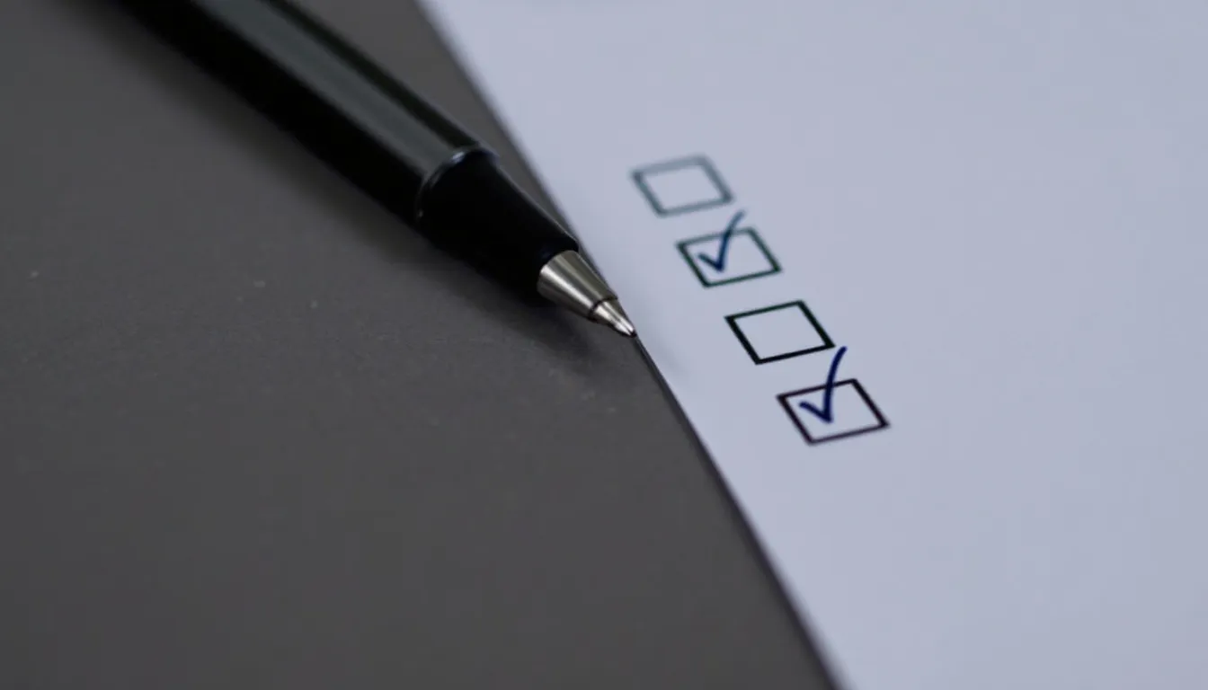 A pen resting beside a printed form with four checkboxes, two of them ticked